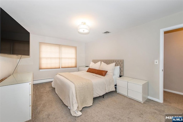 bedroom featuring baseboard heating, light carpet, baseboards, and visible vents
