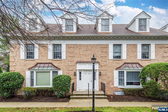view of front of house featuring brick siding