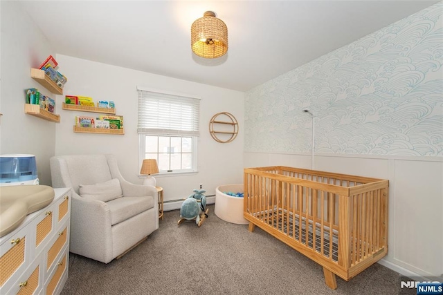 bedroom with carpet floors, a baseboard heating unit, and a nursery area