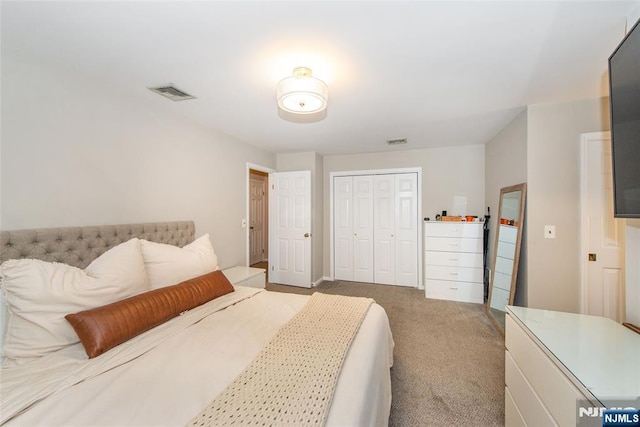 carpeted bedroom featuring visible vents and a closet