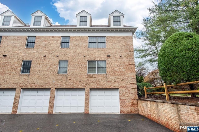 exterior space with fence and aphalt driveway