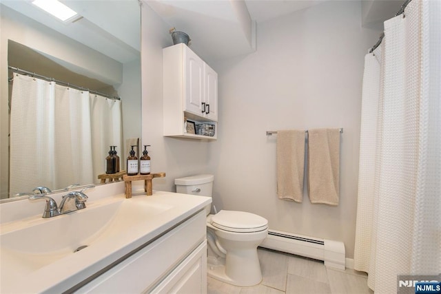 bathroom featuring vanity, a baseboard heating unit, and toilet