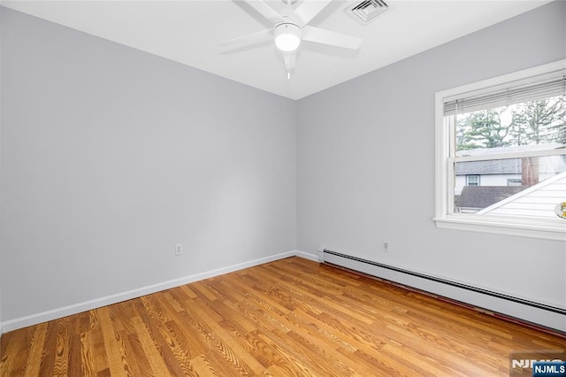 empty room with a baseboard radiator, a ceiling fan, light wood-style flooring, baseboards, and visible vents