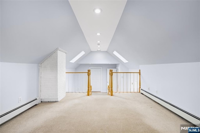 additional living space with a baseboard heating unit, lofted ceiling with skylight, carpet, and recessed lighting