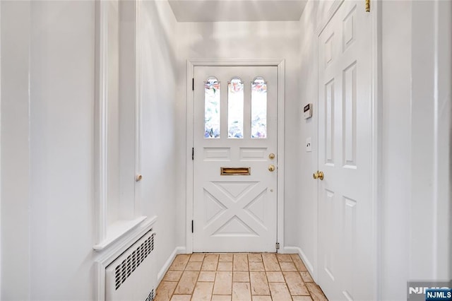 doorway with baseboards, stone finish floor, and visible vents