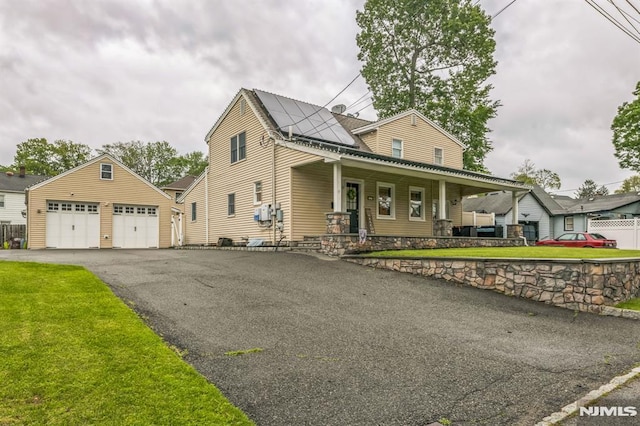 2 Beechwood Ave, Par-Troy Hills Twp, NJ 07034 - view of front of house featuring a porch, an outbuilding, solar panels, and a front yard
