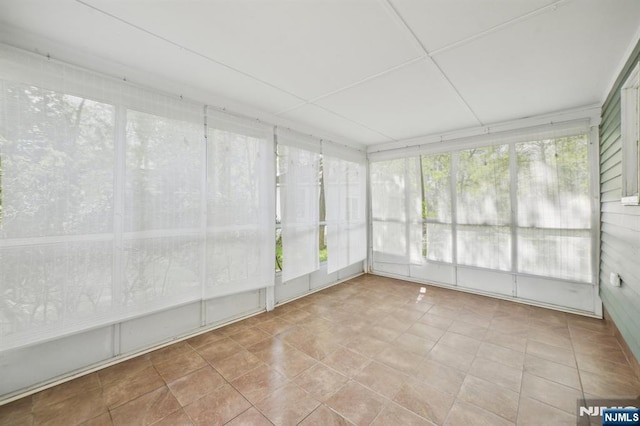 unfurnished sunroom with tile patterned flooring