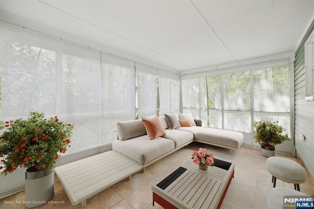 sunroom / solarium with tile patterned floors and healthy amount of natural light