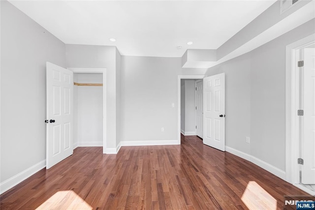 unfurnished bedroom with recessed lighting, visible vents, baseboards, and wood finished floors
