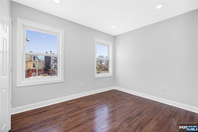 unfurnished room with wood finished floors and baseboards