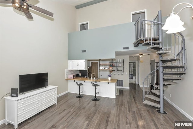 3 Davos Dr Unit 6, Vernon, NJ 07462 - living area with a high ceiling, stairs, dark wood-type flooring, visible vents, and ceiling fan
