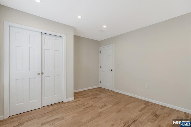 560 18th St, Newark, NJ 07103 - unfurnished bedroom with light wood finished floors, baseboards, recessed lighting, and a closet