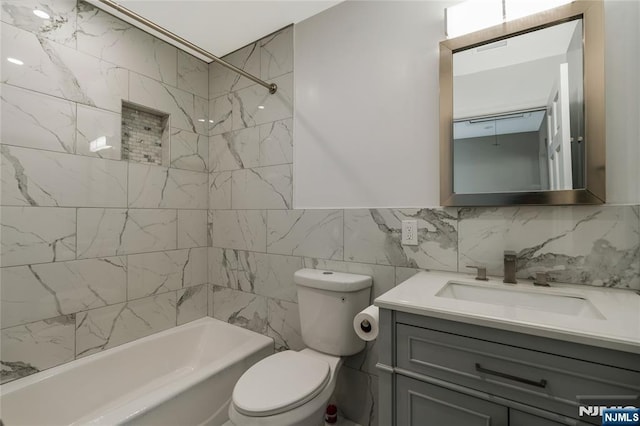 560 18th St, Newark, NJ 07103 - bathroom featuring bathing tub / shower combination, toilet, tile walls, backsplash, and vanity