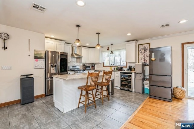 kitchen featuring stainless steel appliances, visible vents, white cabinets, and wine cooler