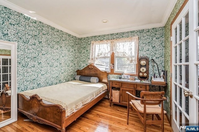 bedroom featuring french doors, light wood-type flooring, wallpapered walls, and crown molding