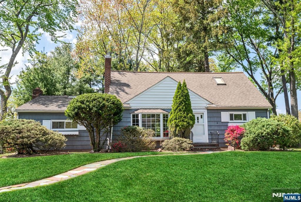 17 Cypress Pl, Demarest, NJ 07627 - view of front facade with a front lawn, a chimney, a shingled roof, and entry steps