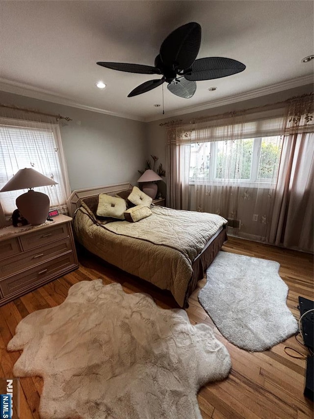 bedroom with wood finished floors, ceiling fan, ornamental molding, and recessed lighting