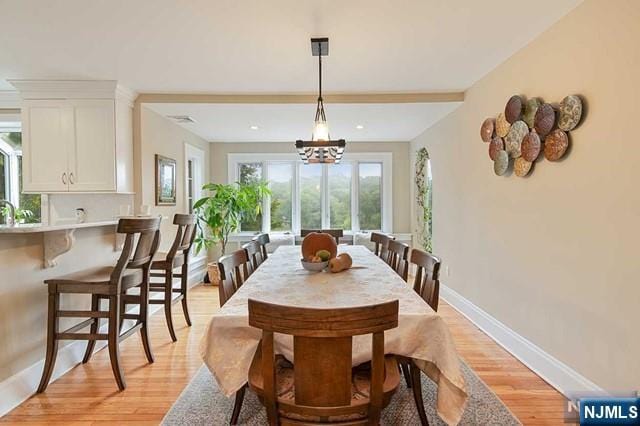 dining room featuring baseboards and light wood finished floors
