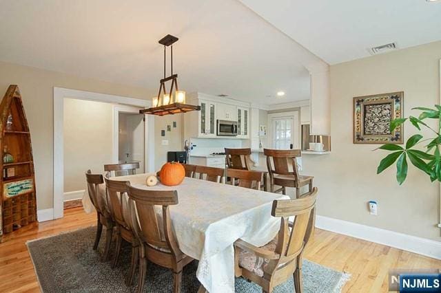 dining room with recessed lighting, light wood-style floors, baseboards, and visible vents