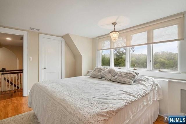 bedroom featuring light wood-style floors and visible vents