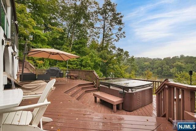 wooden deck featuring a hot tub