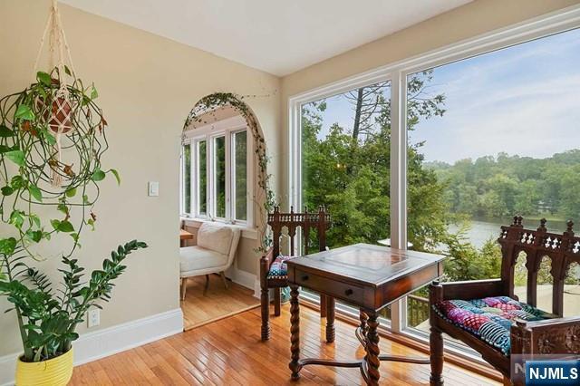 sunroom featuring a water view