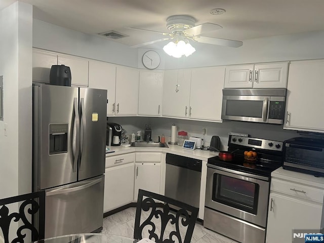 539 Bayway Ave Unit 2B, Elizabeth, NJ 07202 - kitchen with light countertops, visible vents, ceiling fan, marble finish floor, and appliances with stainless steel finishes