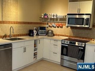 770ANDERS Anderson Ave Unit 4A, Cliffside Park, NJ 07010 - kitchen featuring decorative backsplash, a sink, white cabinets, and stainless steel appliances