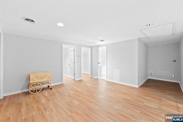 interior space with attic access, baseboards, light wood-style floors, and recessed lighting