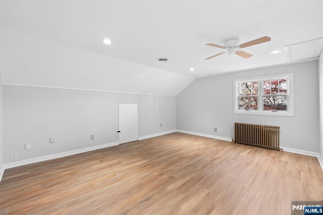 additional living space featuring radiator heating unit, a ceiling fan, baseboards, and vaulted ceiling