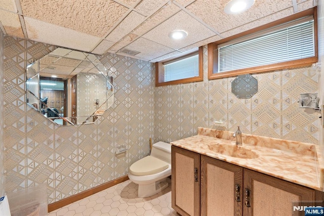 bathroom with toilet, vanity, tile patterned floors, and recessed lighting