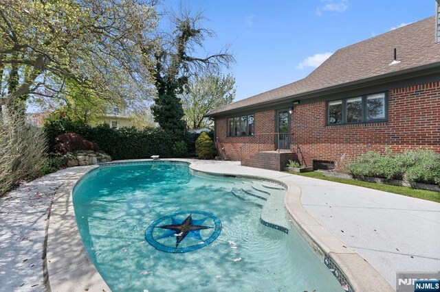 view of swimming pool with a fenced in pool
