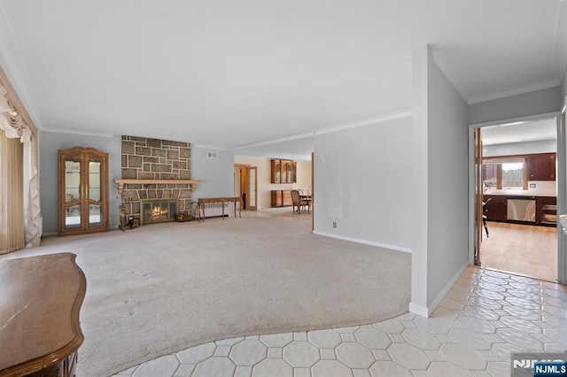 unfurnished living room with baseboards, ornamental molding, carpet flooring, and a fireplace