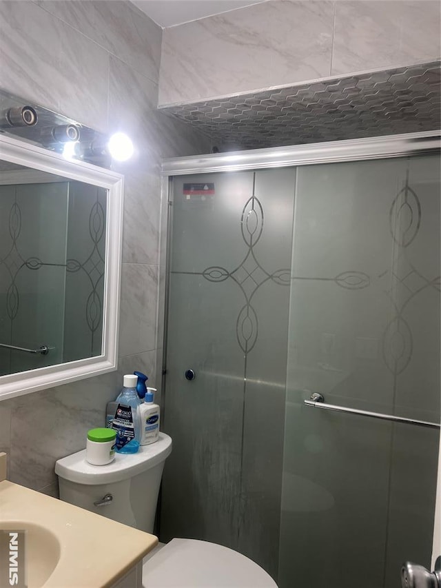 1371 Van Houten Ave Unit 1, Clifton, NJ 07013 - bathroom with tile walls, toilet, vanity, and a stall shower