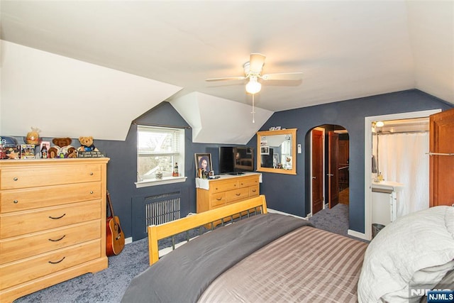 bedroom featuring arched walkways, baseboards, radiator heating unit, lofted ceiling, and carpet floors