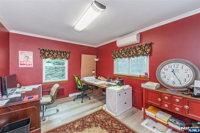 office featuring a wealth of natural light, ornamental molding, light wood-type flooring, and a wall unit AC
