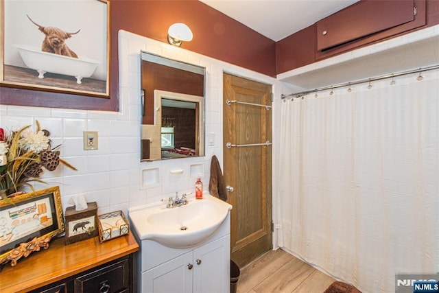 full bathroom with a shower with curtain, wood finished floors, and vanity