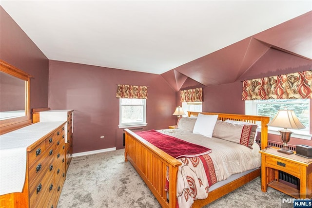 bedroom featuring vaulted ceiling, baseboards, and light colored carpet