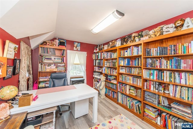 office area with vaulted ceiling and wood finished floors