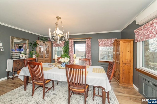 dining room featuring radiator, light wood finished floors, a wall unit AC, baseboards, and a notable chandelier