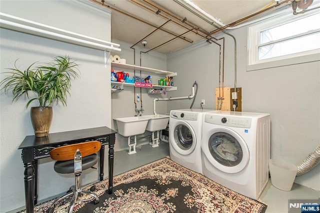 washroom with separate washer and dryer and laundry area