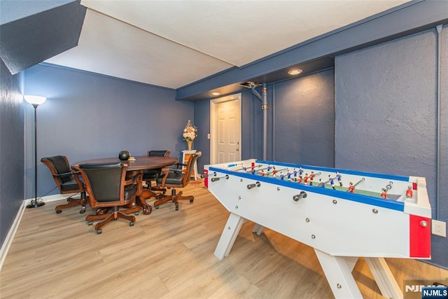 recreation room with light wood-style flooring and baseboards