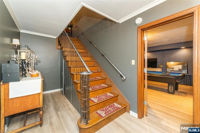 staircase with baseboards, crown molding, wood finished floors, and pool table