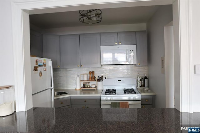 25 River Unit B10, Nutley, NJ 07110 - kitchen with decorative backsplash, gray cabinetry, and white appliances