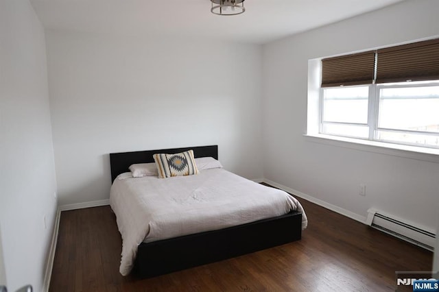 25 River Unit B10, Nutley, NJ 07110 - bedroom with a baseboard heating unit, wood finished floors, and baseboards