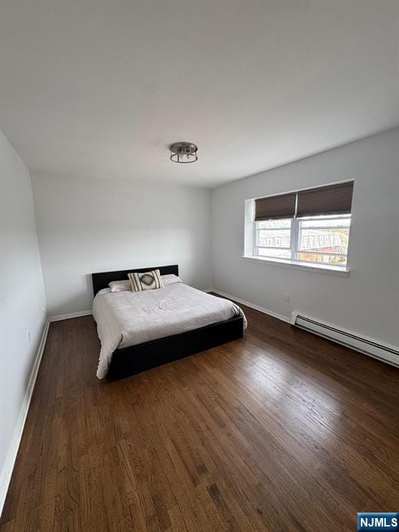 25 River Unit B10, Nutley, NJ 07110 - bedroom featuring dark wood-type flooring, baseboards, and baseboard heating