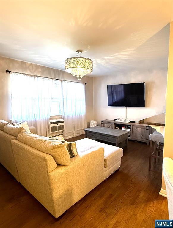 25 River Unit B10, Nutley, NJ 07110 - living room with a chandelier, dark wood-type flooring, and cooling unit