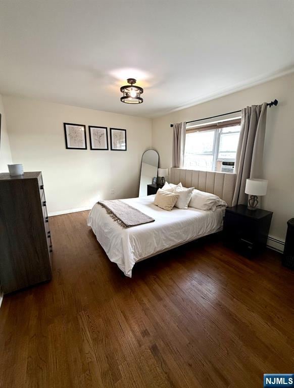 25 River Unit B10, Nutley, NJ 07110 - bedroom featuring dark wood-type flooring and a baseboard radiator