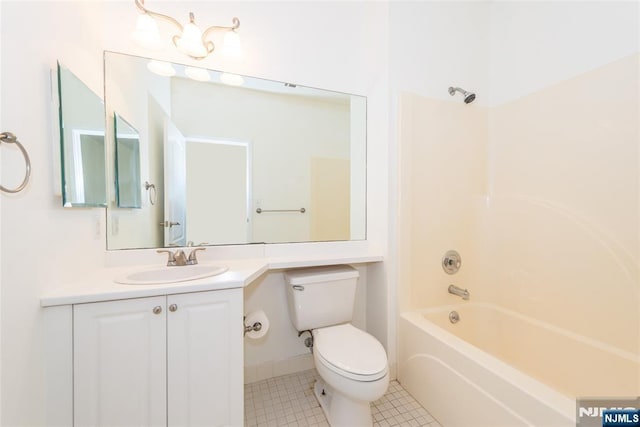 full bath featuring toilet, tile patterned floors, vanity, and washtub / shower combination