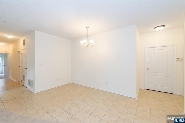 unfurnished room with light tile patterned floors, visible vents, baseboards, and an inviting chandelier